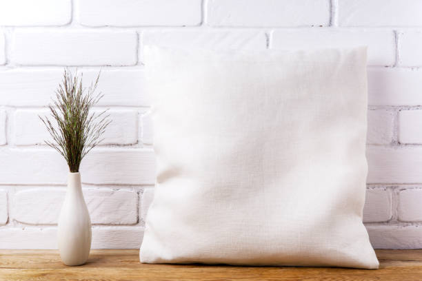Pillow mockup with big bluestem wild grass Square cotton pillow mockup with big bluestem wild grass. Rustic linen pillowcase mock up for design presentation cushion photos stock pictures, royalty-free photos & images