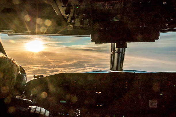 Pilot enjoying view Pilot of commercial aircraft is enjoying stunning sunrise. cockpit stock pictures, royalty-free photos & images