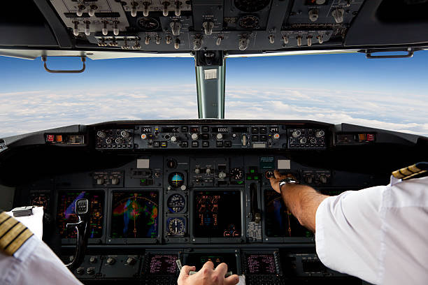 Pilots Working in an Aeroplane During a Commercial Flight stock photo