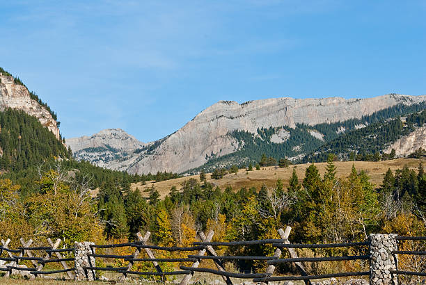 Pine Butte Guest Ranch Fall comes early to the high country of Montana. While the plains are still baking in the heat of summer, the Continental Divide is taking on the hues of autumn. This scene of the Rocky Mountain Front Range was photographed from the Pine Butte Guest Ranch near Choteau, Montana, USA. jeff goulden montana stock pictures, royalty-free photos & images