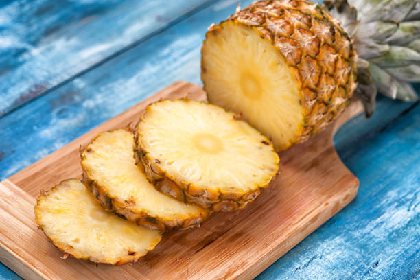 Pineapple on the blue vintage wooden plate stock photo
