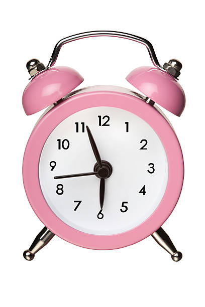 Pink Classic Bell Alarm Clock on White With Clipping Path stock photo
