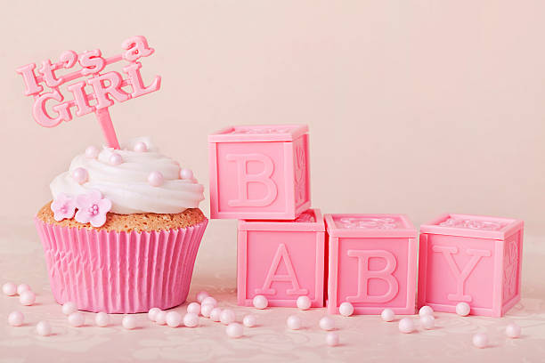 Pink cupcakes with pink baby blocks Cupcake with a cake pick and baby cubes it's a girl stock pictures, royalty-free photos & images