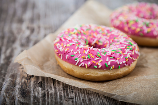 Download Pink Donuts On Paper Stock Photo - Download Image Now - iStock