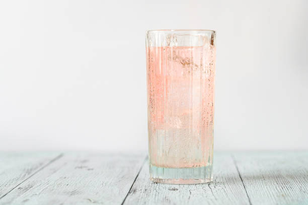 Pink gin cocktail Glass of pink gin and tonic cocktail highball glass stock pictures, royalty-free photos & images