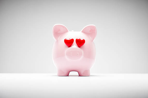 Pink Piggy Bank with Heart Shaped Eyes stock photo