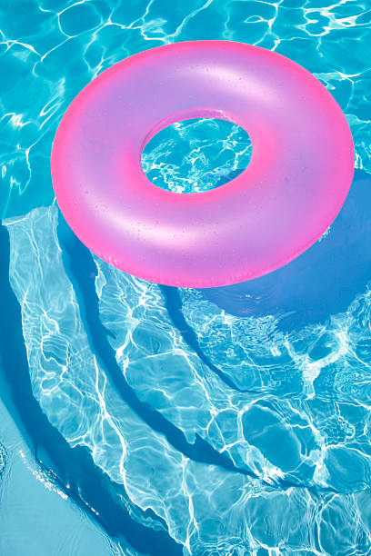 Pink Ring Floating in a Blue Pool stock photo