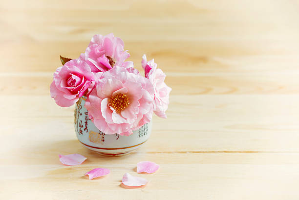 Pink roses in a vase on the table. stock photo