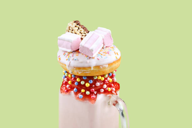 pink strawberry freakshake with marshmallow and sweets. - freakshake fruit stockfoto's en -beelden