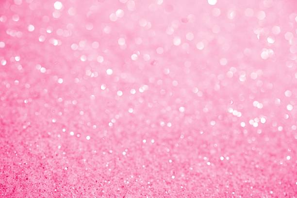 Pink Sugar Sparkle Background XXXL photo of crystal glittery pink sugar with selective focus along bottom to create blurred sparkles over most of the top 3/4ths for copy space.  Bright and sweet background. femininity stock pictures, royalty-free photos & images