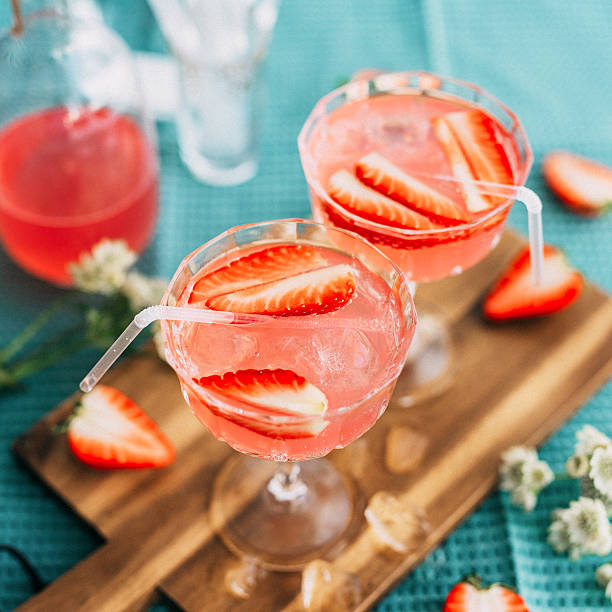 Pink summer cocktail drink with strawberries stock photo