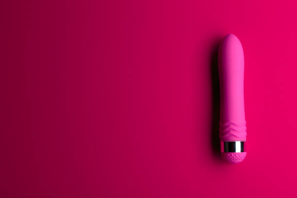 pink vibrator on the pink background with copy space - hookup stock picture...