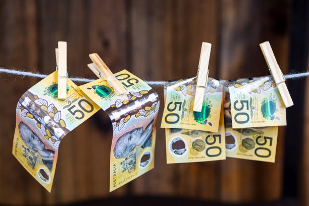 pinned banknotes on a clothes line. concept of money laundering Money pinned on a washing line money laundering stock pictures, royalty-free photos & images