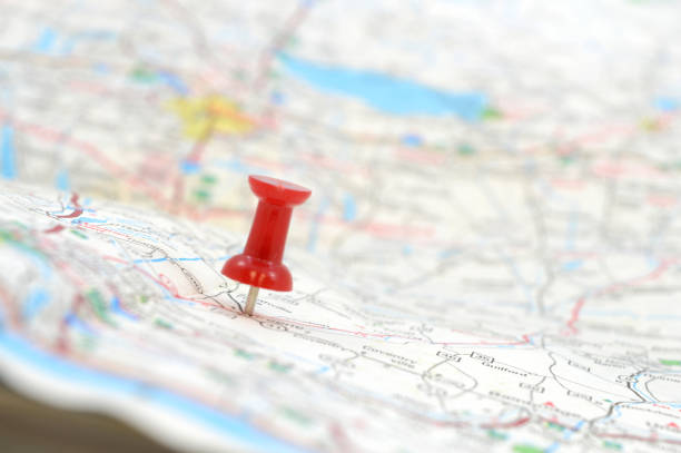 Pinpoint Mapped Destination A traveler has used a red pushpin to position the mapped out destination, shallow dof with the focus on the red tack. pointing photos stock pictures, royalty-free photos & images