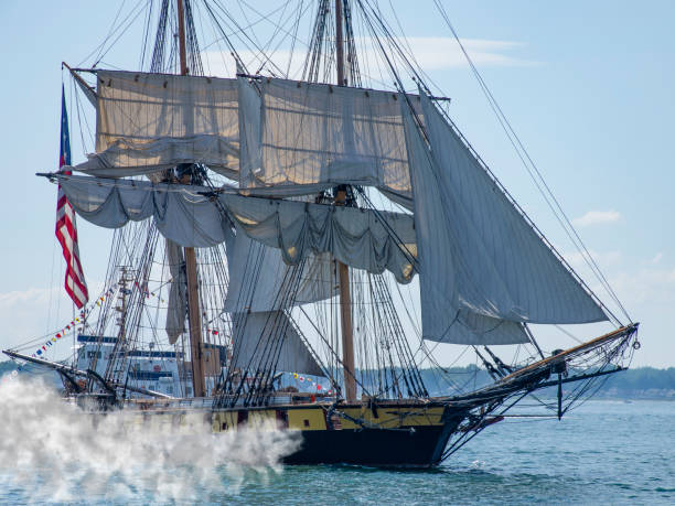 Pirate ship firing its cannons Reenactment of tall pirate sailing ship firing its cannons buffalo shooting stock pictures, royalty-free photos & images
