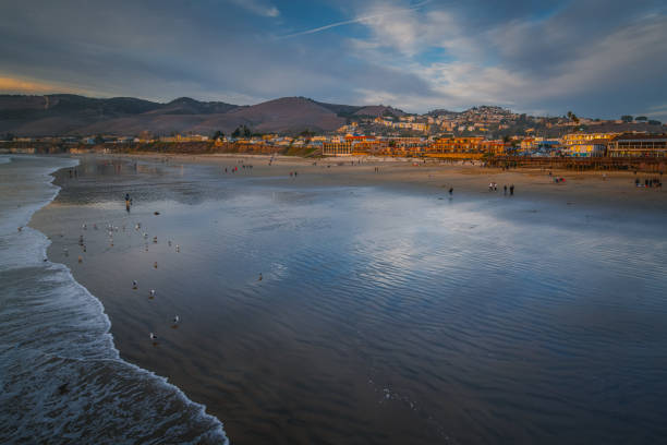 Pismo Beach, charming beach town in San Luis Obispo County, California. Waterfront, beach hotels, golden hills, and people enjoying sunset. stock photo