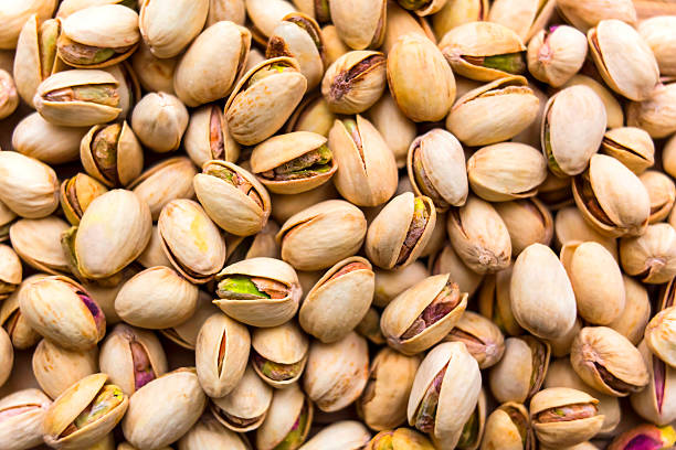 pistachios Group of fresh salted pistachios background pistachio stock pictures, royalty-free photos & images