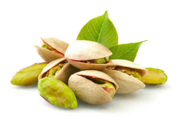 Pistachios with leaves isolated on white Pistachios with leaves isolated on white background pistachio stock pictures, royalty-free photos & images