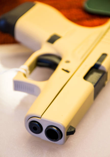 Pistol laying on Counter at a Gun store in Texas after another school shooting Pistol laying on Counter at a Gun store in Texas after another school shooting texas school shooting stock pictures, royalty-free photos & images