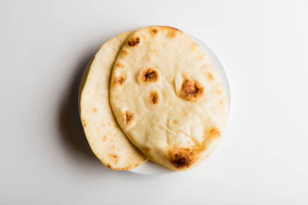 Pita bread or naan. Ingredients for restaurant cooking from farmers markets. Photographed on white background. Fresh Fruits & vegetables from farmers market. Classic ingredients, garnishes used in cooking. Meats, veggies, herbs & spices. stock photo