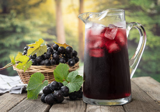 Pitcher of Grape Juice With Fresh Grapes stock photo