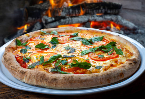 Pizza basil tomato and mozzarella stock photo