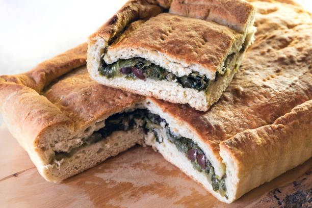 Pizza homemade stuffed with escarole, olives and capers. stock photo