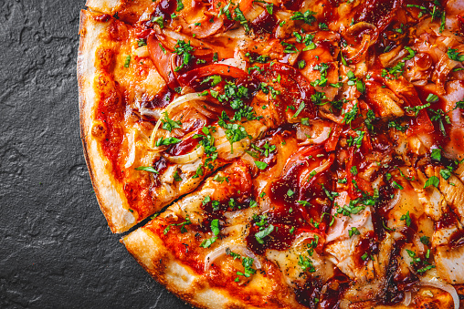 Pizza with chicken and barbeque sauce. Italian pizza on Dark grey black slate background