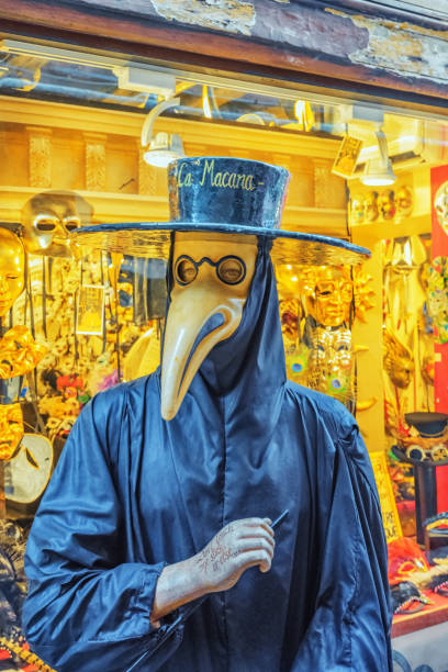 Plague doctor costume was a medical physician who treated victims of the plague. They were specifically hired by towns that had many plague victims in times of epidemics. Venice. Venice, Italy - May 11, 2017 : Plague doctor costume was a medical physician who treated victims of the plague. They were specifically hired by towns that had many plague victims in times of epidemics. Venice. Italy. bubonic plague photos stock pictures, royalty-free photos & images