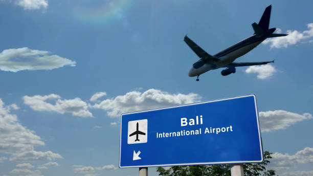 Plane landing in Bali Indonesia airport with signboard stock photo