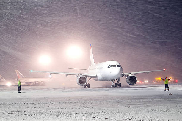 plane parked at the airport in winter stock photo