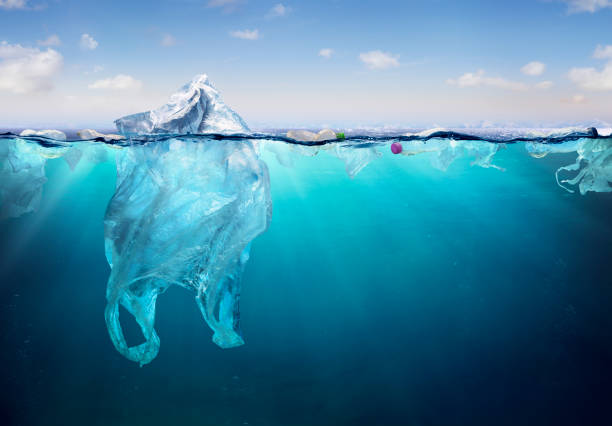 Plastic Bag Floating On Sea - Environmental Problem Plastic Pollution In Ocean - Plastic Bag Floating On Sea - Environmental Problem contamination stock pictures, royalty-free photos & images
