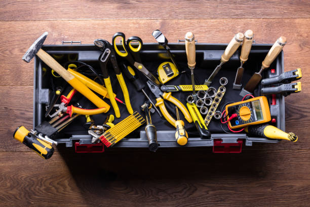 Plastic Black Container With Many Tools Elevated View Of Plastic Black Container With Many Tools On Wooden Table toolbox stock pictures, royalty-free photos & images