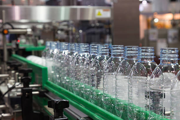 plastic bottle on factory line machine in the factory - manufacture plastic imagens e fotografias de stock