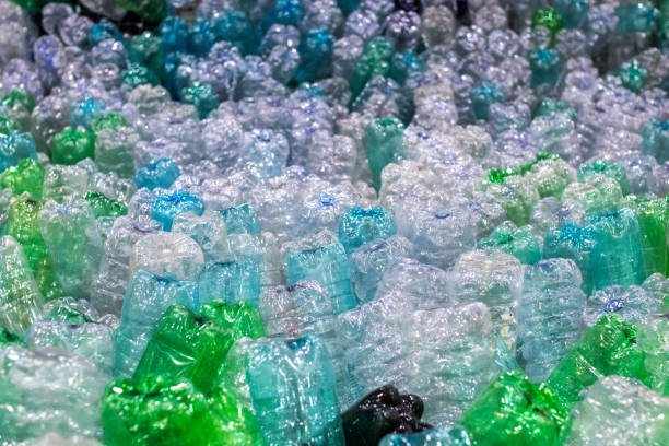 PET plastic bottles stacked. Plastic recycle system PET plastic bottles stacked in groups in a plastic recycling plant. Plastic recovery process circular economy stock pictures, royalty-free photos & images