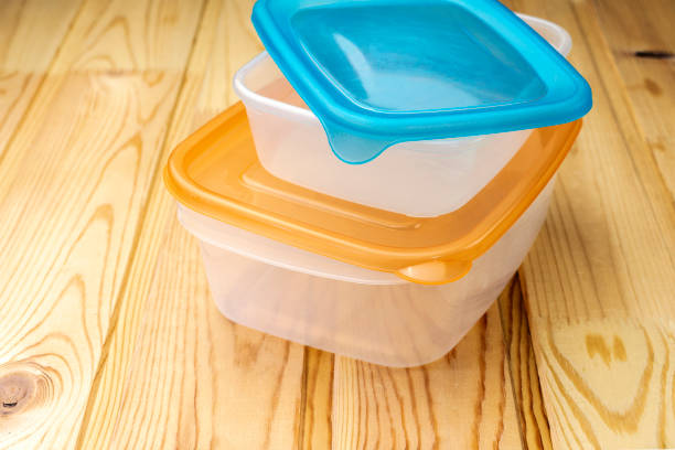 Plastic food containers on a wooden table Plastic food containers on a wooden table plastic container stock pictures, royalty-free photos & images