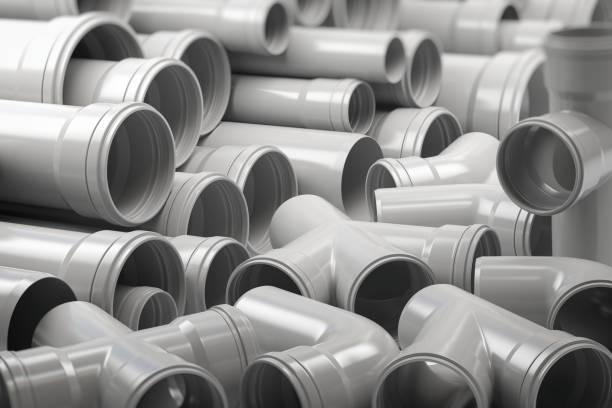 PVC plastic pipes and tubes stacked in warehouse. PVC plastic pipes and tubes stacked in warehouse. 3d illustration pvc stock pictures, royalty-free photos & images