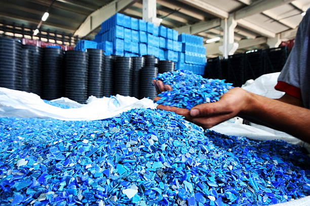 plastic resin pellets in holding hands - recycle stockfoto's en -beelden
