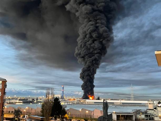 Plastic storage fire causing enviromental emergency in the city stock photo
