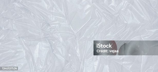 istock Plastic transparent cellophane background. White texture background 1345137534