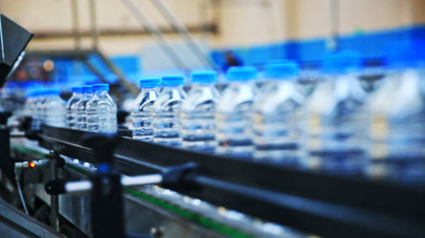 Plastic water bottles in factory on conveyor belt stock photo
