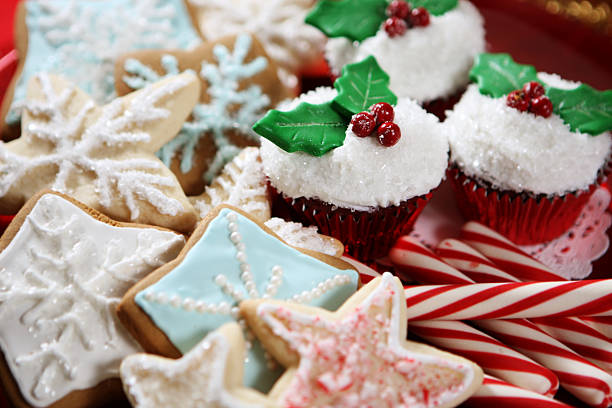 A plate of Christmas cookies, cupcakes and candy canes stock photo