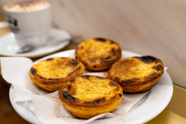 plate of freshly baked egg tart or custard tart (pastel de nata), a famous dessert in lisbon portugal. selective focus - pastel de nata imagens e fotografias de stock