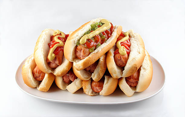 Plate Of Hotdogs Plate of stacked hotdogs.  Ketchup, mustard, and relish. sausage photos stock pictures, royalty-free photos & images