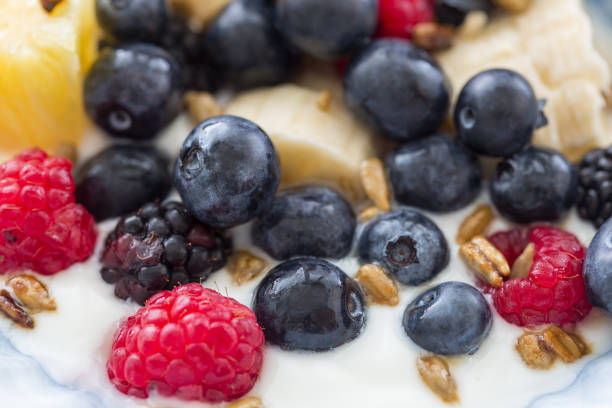 Plate of mixed fruits with yogurt stock photo