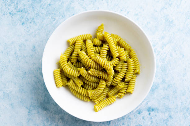 Plate of pasta with pesto Genovese, with fresh basil, olive oil, garlic and pine nuts stock photo