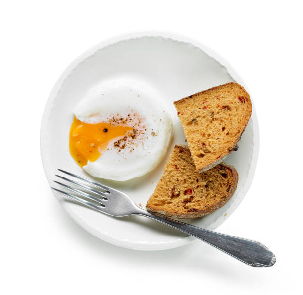 Plate of poached egg and bread Plate of poached egg and bread isolated on white background, top view poached food stock pictures, royalty-free photos & images