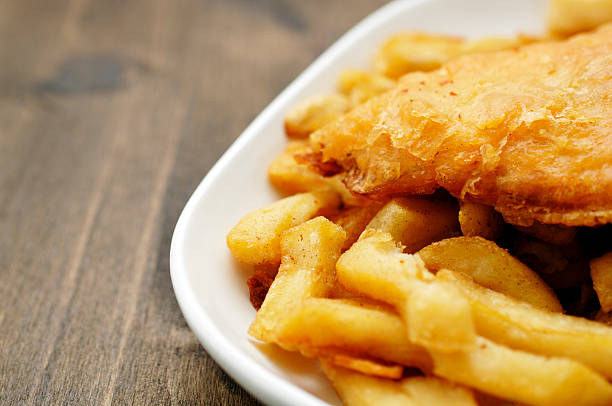 plate of traditional English fish and chips plate of traditional English fish and chips fried fish stock pictures, royalty-free photos & images