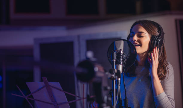 Playback singer recording album in the studio Female playback singer recording album in the professional studio. Woman singing a song in music recording studio. singer stock pictures, royalty-free photos & images
