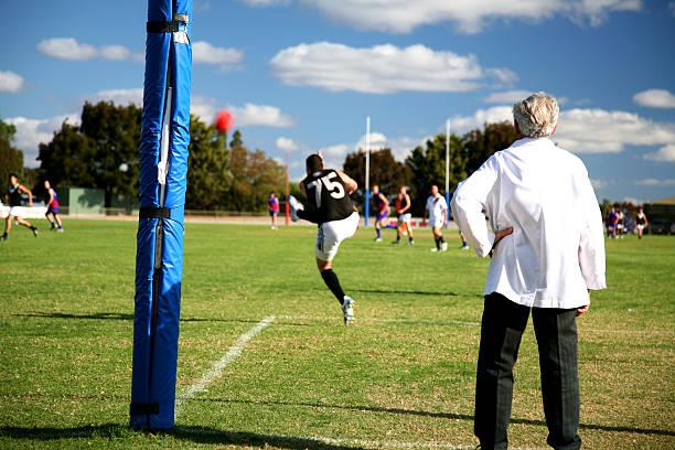A player kicking the ball during practice in the field stock photo